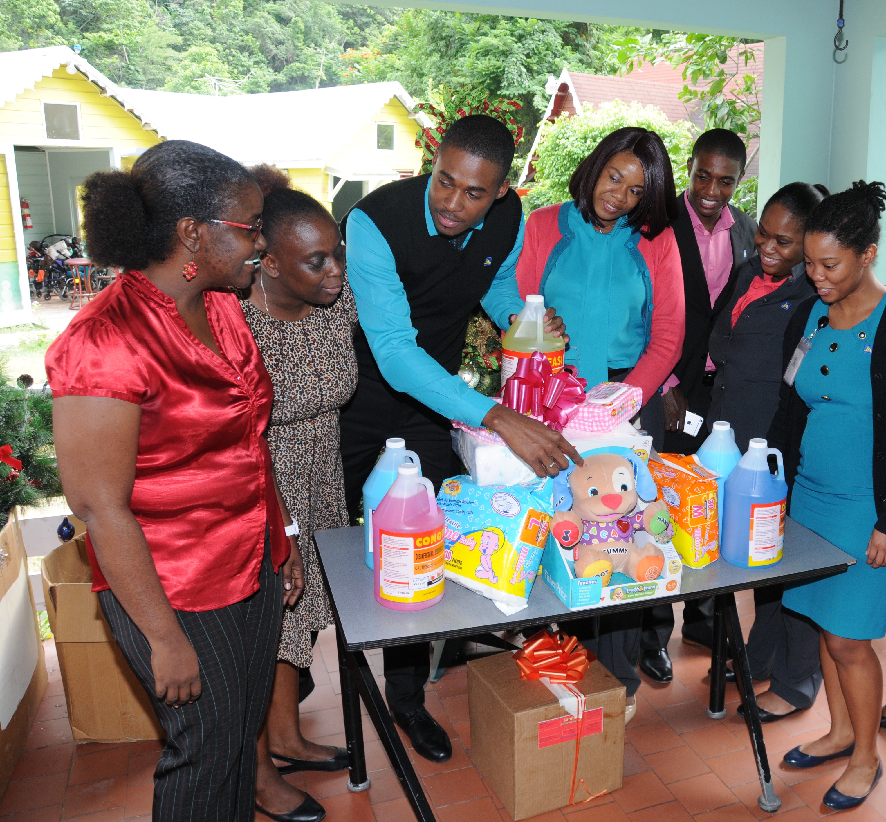 Sophie's Place - JN Bank Opal Bailey (left), Childcare Manager of Sophie’s Place and Christine Watson (second left), Matron, Sophie’s Place; are delighted to receive donation of supplies from employees of The Jamaica National Group, who have for the past 10 years have been helping to sponsor the cost of medication for the children of the home every month.
