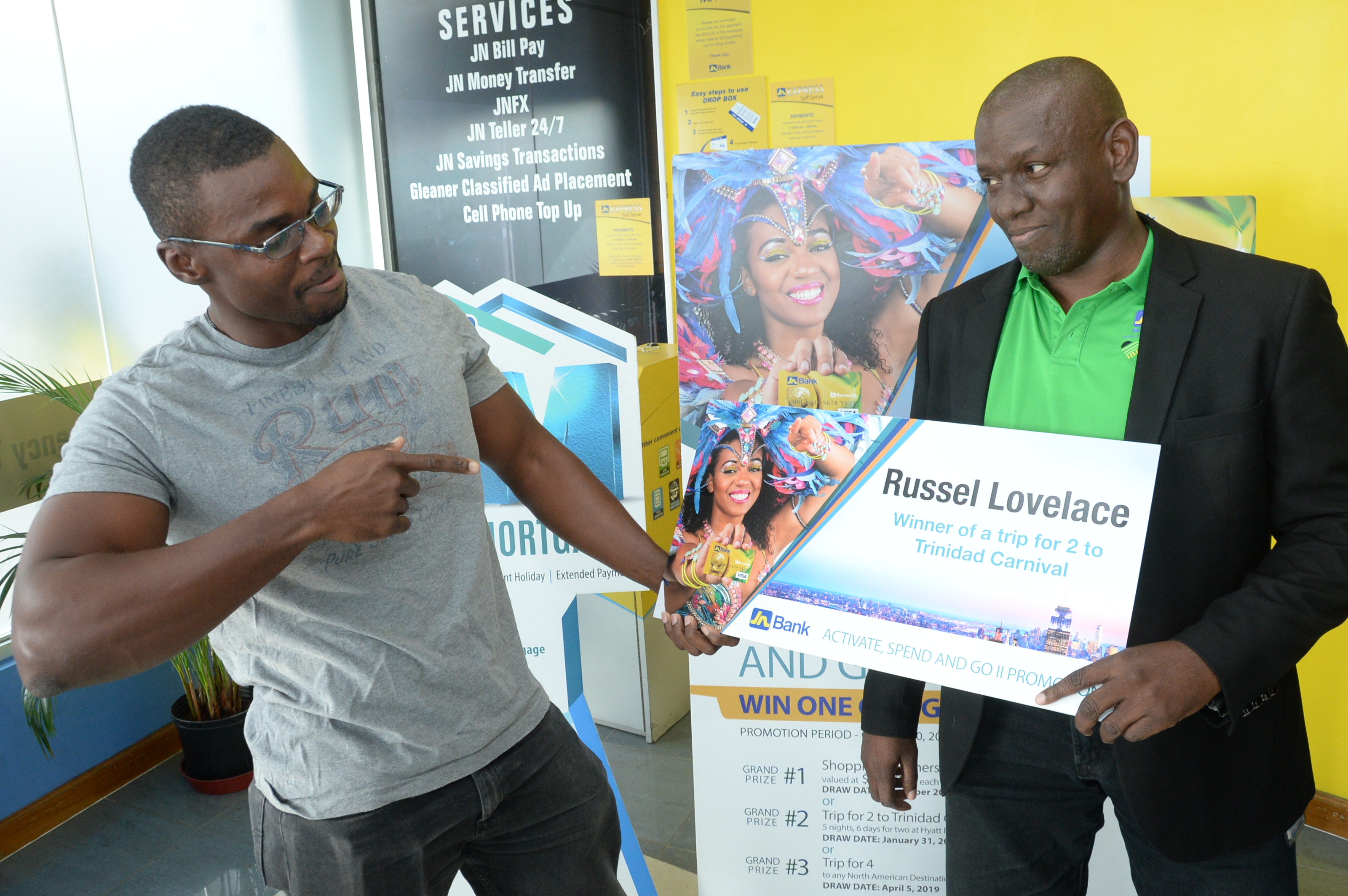 ACD_0186 - JN Bank Like many soca lovers, “playing mas” in Trinidad and Tobago Carnival has been a life-long dream for Russell Lovelace. Thanks to JN Bank, he can now cross this item off his ‘bucket list,’ as come March 4 and 5, the 24-year-old will be among thousands of revelers prancing and masquerading through the streets of Port-of-Spain. On Friday, February 22, Mr Lovelace was presented with the grand prize of an all-expense paid trip for two, to Trinidad Carnival, after simply activating and spending approximately $10,000 with his JN Bank VISA credit card. “This is a dream come true. I have been a soca fan all my life; and going to Trinidad Carnival was one of the things I’ve always wanted to experience,” he said. “My girlfriend is even more ecstatic about this trip than I am; and, we are planning to have a great time together.” Mr Lovelace, who describes himself as a “technician by day” and a “soca-warrior by night,” will depart Jamaica with his girlfriend, Sashay Salmon, on Thursday, February 28. They will spend six days and five nights at the Hyatt Regency in Port-of-Spain, courtesy of JN Bank. As part of their prize package, they will also receive US$500 spending money, pre-paid tickets to three carnival fetes, and two free carnival costumes. The Kingston-native said he is mostly looking forward to the road marches; as, he wants to compare how the Trinidad Carnival experience equates with the Jamaican Carnival. “I have always heard stories about Trinidad Carnival; and many persons say that it’s the “mother of all West Indian carnivals,” therefore, I am definitely looking forward to the experience. I have also never ‘played mas,’ but, have always watched from the sidelines; therefore, this will be a new and welcomed experience from all angles,” he related. Mr Lovelace, who is also a “gym fanatic” said he is physically ready for the carnival festivities, which can be a grueling test of endurance. “I always find time to work out at least three days a week, hence I definitely have the stamina to keep up with the road marches,” he said. He and Sashay are also planning to do some “sightseeing” in Trinidad prior to returning to Jamaica. The JN Bank’s “Activate, Spend and Go,” promotion is still open to persons with a JN VISA Credit Card. The promotion continues until April 5, 2019, when the third and final draw of a trip for four, to any North American destination via Jet Blue airline, will be made. The first draw under the promotion was made in December 2018, when three persons won gift vouchers valued at $150,000 each, for shopping sprees at Singer Jamaica and Megamart.